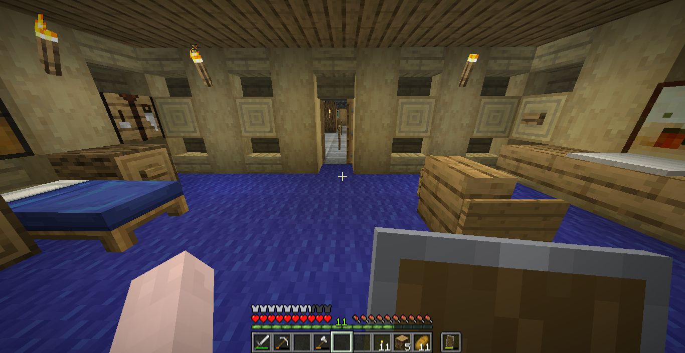 A bedroom from the hobbit hole, with blue carpet.
