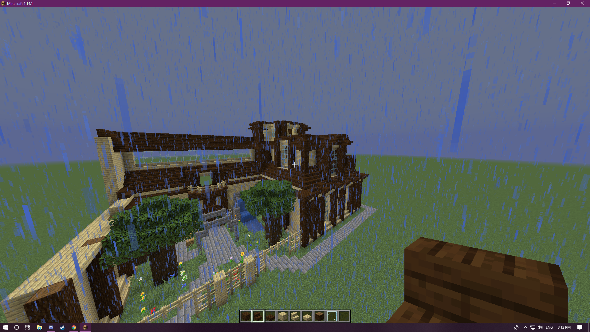 A behind view of the same house, with a garden.